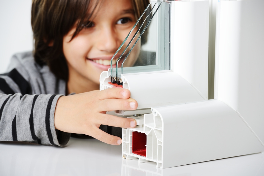 Kid holding plastic window profile